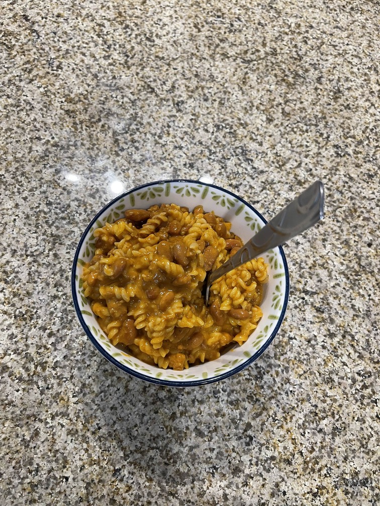 [a photograph of a bowl of mac and chili with a fork in it]